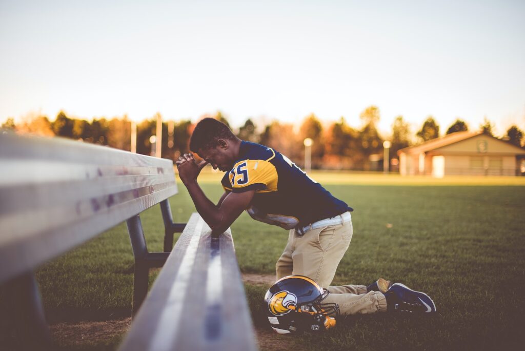 baseball player kneeling on ground